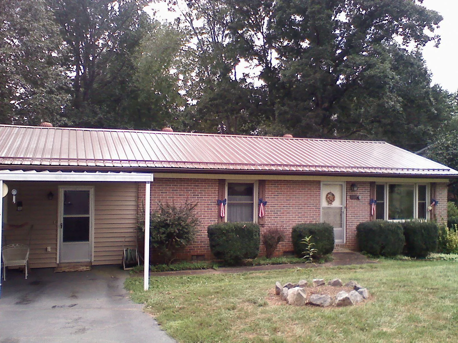 Bronze metal roof and carport on a brick ranch home — Roof Repair work by our crew in Ardsley